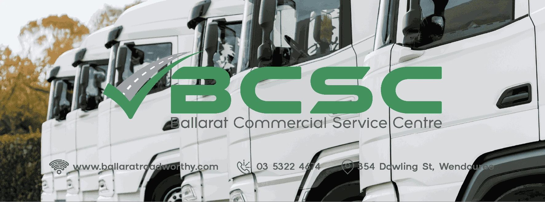 A BCSC branded truck cab showing the workshop's phone number and Dowling Street address